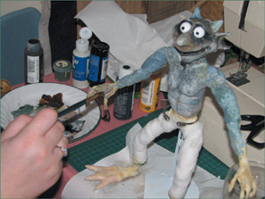 The puppet is covered with acrylic paint.