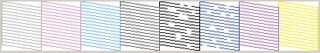 A nozzle check pattern showing clogging in the black and blue nozzles