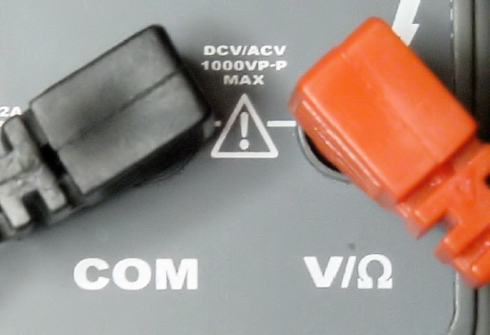 Common and voltage test lead terminals on multimeter
