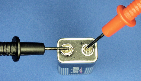 Probe tips touching battery terminals