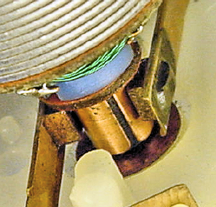 Shaft installed in the cap with brushes pressed against the commutator