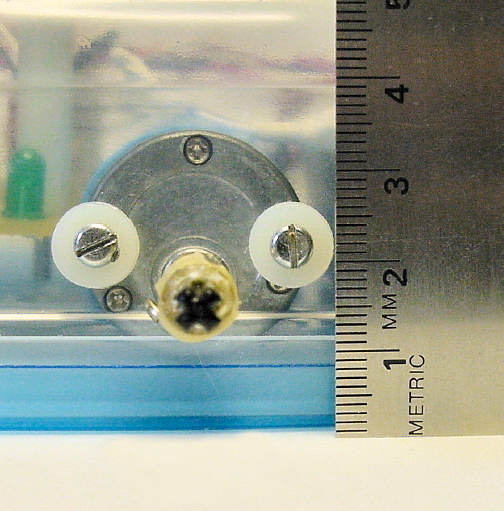 A ruler measuring the height from the surface to the center of the motor shaft