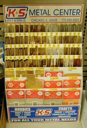 Hardware store display case of brass, aluminum, and copper in the shape of tubes, angles, channels, strips, and sheets