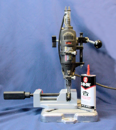 Dremel rotary tool installed on a Dremel drill press. Optional oil and drill-press vise also pictured.