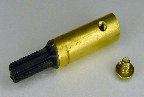 Finished coupler displaying beautiful screw threads. Alongside, a #4–40, 1/8-inch long panhead machine screw.