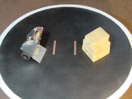 Bugdozer, a mini-sumo robot, faces off against a less capable challenger, Pound of Wood.