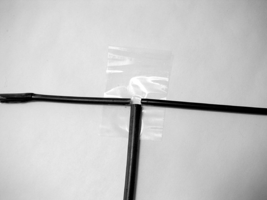 Secure the cross bars with packing tape and bend them in place.