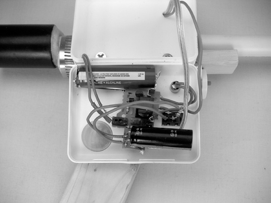 The enclosure, with all electronics mounted on the lid; the set of wires threaded out the topmost hole run from the flash bulb’s wires to the spark plug