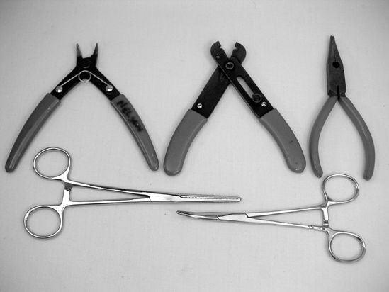 Clockwise from top left: diagonal cutters, wire strippers, needle-nose pliers, and two types of clamps