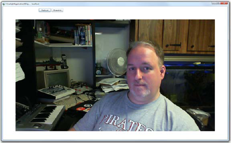 Webcam screen shot at 720p HD, selected using the Desired-Format property and LINQ. I'm practicing my raised-eyebrow news anchor face. I'll try harder next time. Dig the C128 in the background!