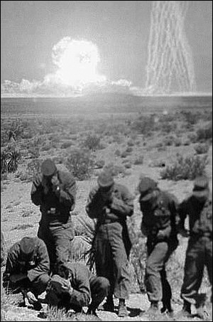 To avoid looking directly at an atomic bomb blast, US soldiers cover their faces with their hands. This is the same position government authorities will later use to avoid looking directly at these veterans while refusing to grant compensation for illnesses suffered as a result of excessive radiation exposure.