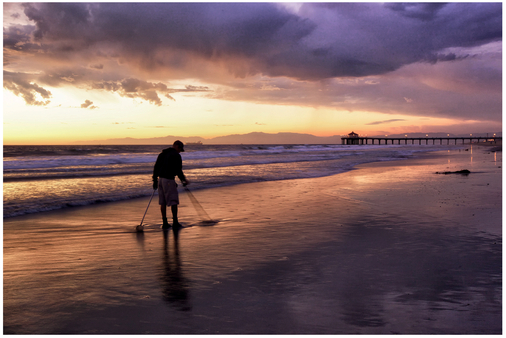 FIGURE 24 We had been photographing sunset at low tide with beautiful colors and wonderful reflections, when all of a sudden someone walked into the frame with a metal detector. Suddenly we had a very different image. It would have been easy to be annoyed with him, but instead we got a little closer and made him an element of the image.