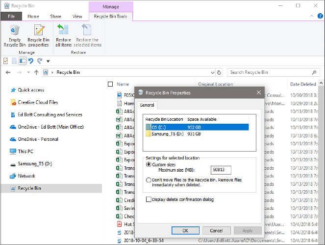 This screenshot shows File Explorer with the Recycle Bin Tools tab on the ribbon visible. The Recycle Bin Properties dialog box is open, showing two drives and settings below them for maximum size and an option to display a delete confirmation dialog box.