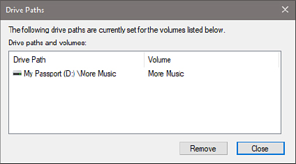 This screenshot shows the Drive Paths dialog box, with a single entry showing a drive path on drive D and a volume called More Music. Remove and Close buttons are at the bottom.