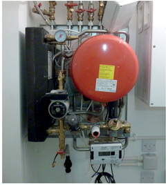 Figure 0.6 Uninsulated, poorly installed heat interface unit (HIU) (right).