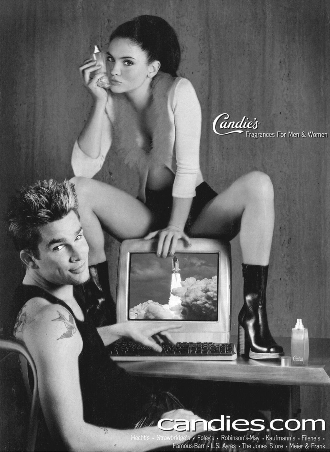 Candie's Fragrances advertisement displaying a man typing on the keyboard and a woman sitting on the monitor.