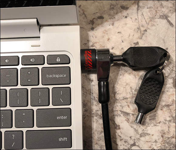 Photo depicts locking the Chromebook with a security cable lock.