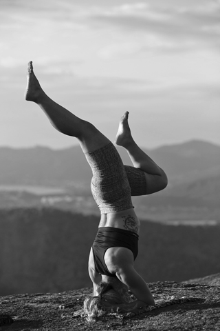Image of a woman in yoga position (shoulderstand).