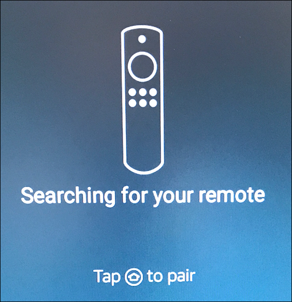 Image displaying the message “Searching for your remote,” to press the Home button enabling the Fire TV Stick and the Alexa Voice Remote to connect (or pair) with each other. 