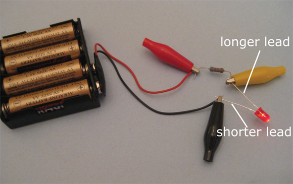 Alligator clips connect components in this simple LED circuit.