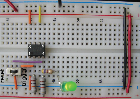 The SPDT switch is used to both trigger and reset the 555 timer in this flip-flop circuit. (Pin and switch labels have been added.)