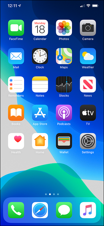 Screen capture depicting iPhone home screen unlocked with sixteen app icons at the top and four apps at the bottom for call, Safari, WhatsApp, and iTunes.
