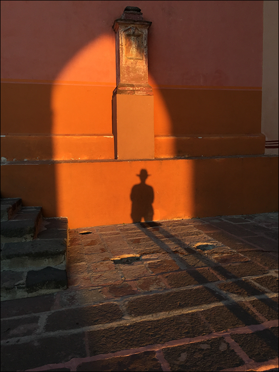Photo depicts the rays of light at sunrise or sunset that allows unusual shadow portraits.