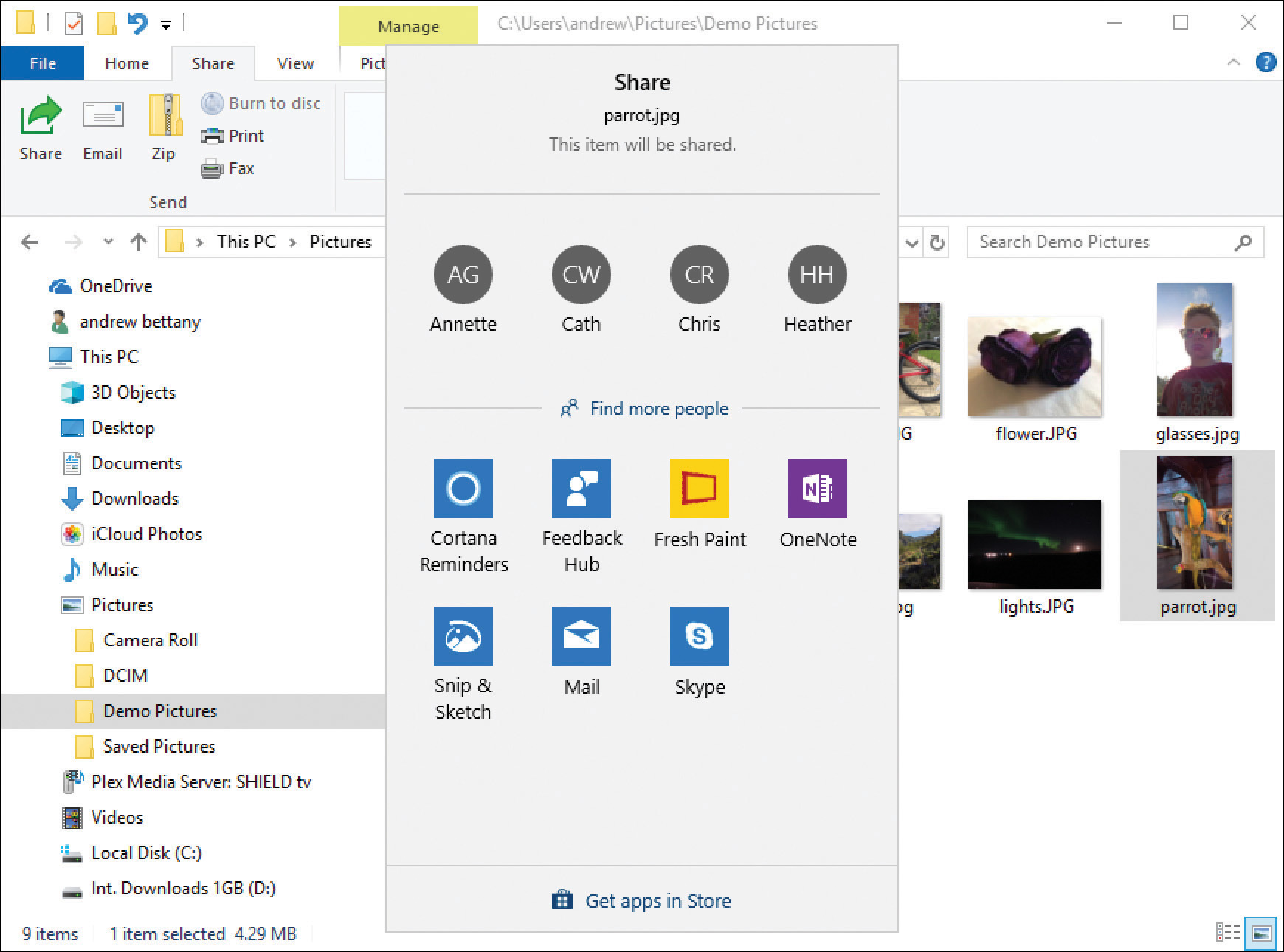 A screenshot shows the File Explorer with the Demo Pictures folder selected and a photograph of a parrot selected. The context share menu is shown in the foreground with a list of four users at the top, Annette, Cath, Chris, and Heather, and below are app icons for Cortana Reminders, Feedback Hub, Fresh Paint, OneNote, Snip & Sketch, Mail, and Skype.