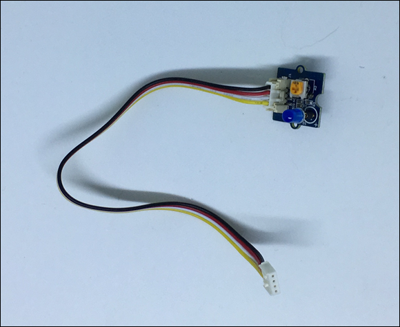 Photo depicts a Grove cable plugged into the Grove blue LED board.