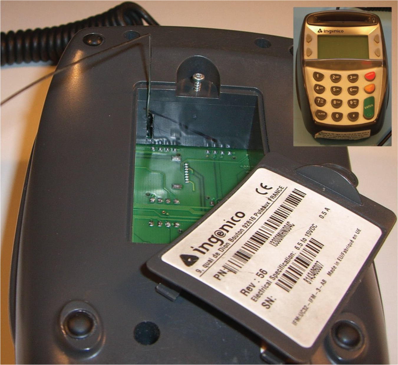 Photo depicts a rigid wire is inserted through a hole in the Ingenico’s concealed compartment wall to intercept the smartcard data. The front of the device is shown on the top right.