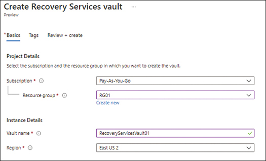 A screenshot showing the Basics tab in the Create Recovery Services Vault wizard in the Azure Portal. Subscription is set to Pay-As-You-Go, Resource Group is set to RG01, Vault Name is set to RecoveryServicesVault01, and Region is set to East US 2.