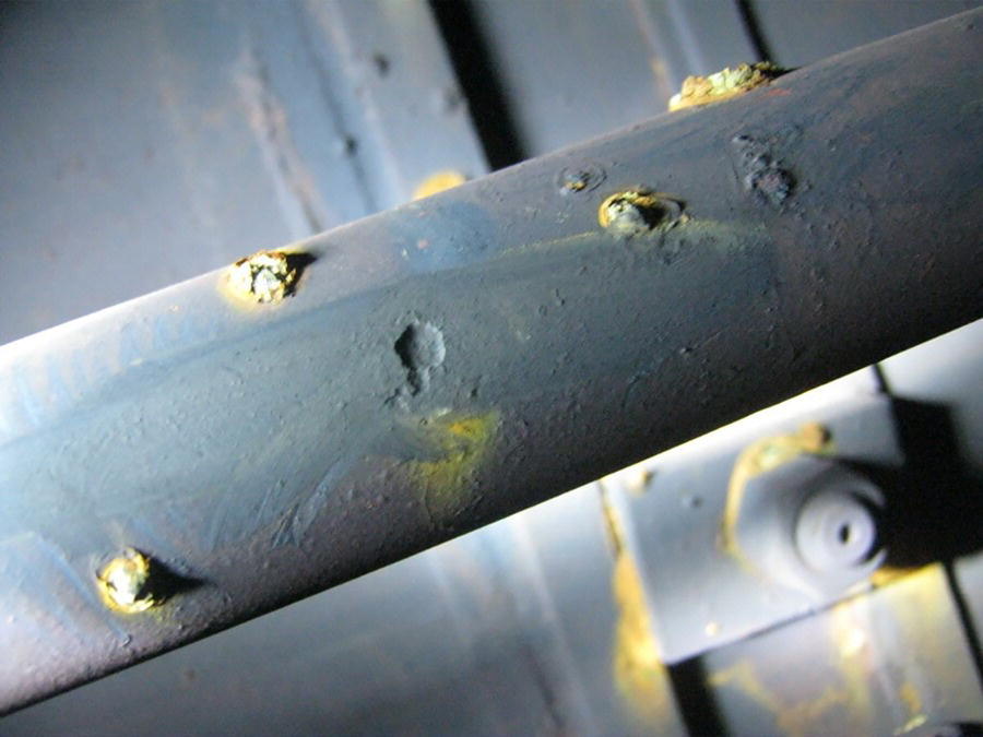 Photo depicts underdeposit corrosion in a water tube utility boiler.