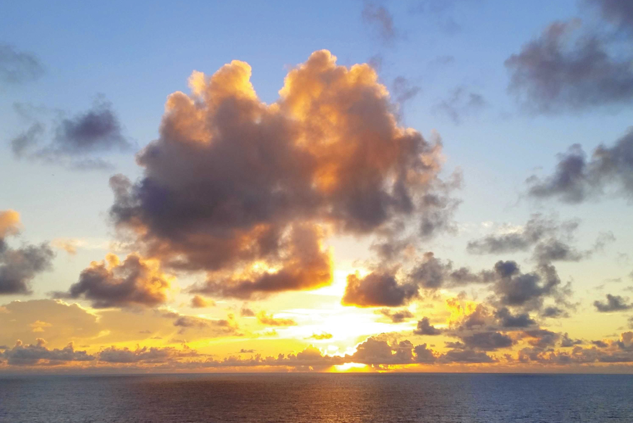 Photo depicts the sun sets dramatically on the Atlantic Ocean.