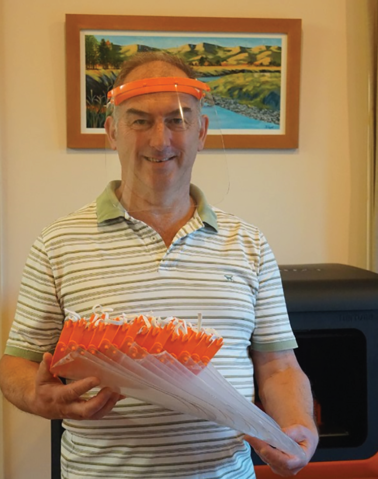 Photograph of Fonterra Research Technologist Richard Lloyd used an office 3D printer to produce frames for protective visors for essential health workers.