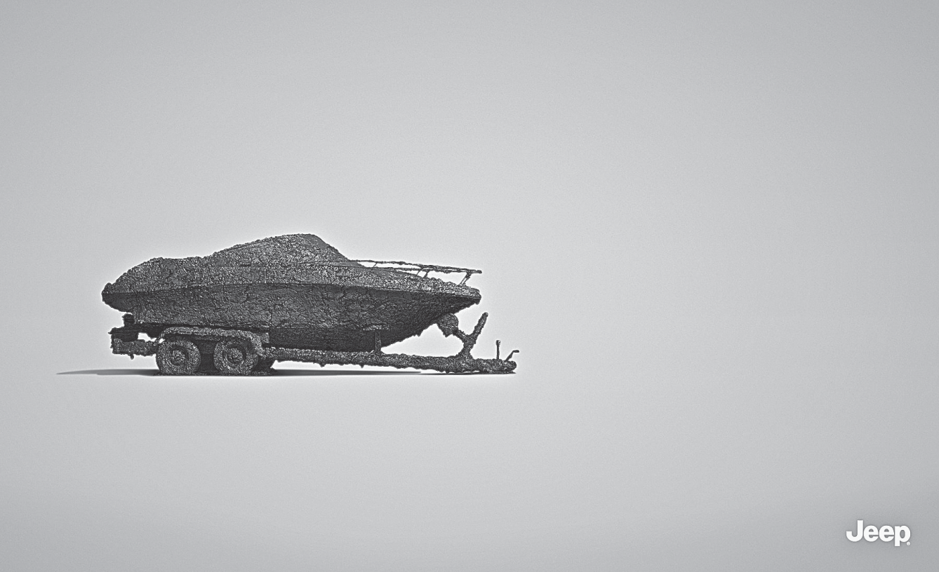 Photograph shows no headline. No product. Just a mud-caked boat on a trailer. For Jeep.