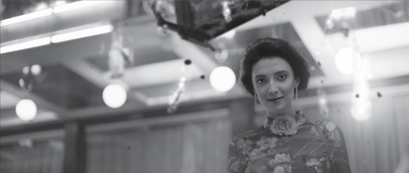 Photograph of a beautifully dressed woman appears to be under a falling, flaming piano.