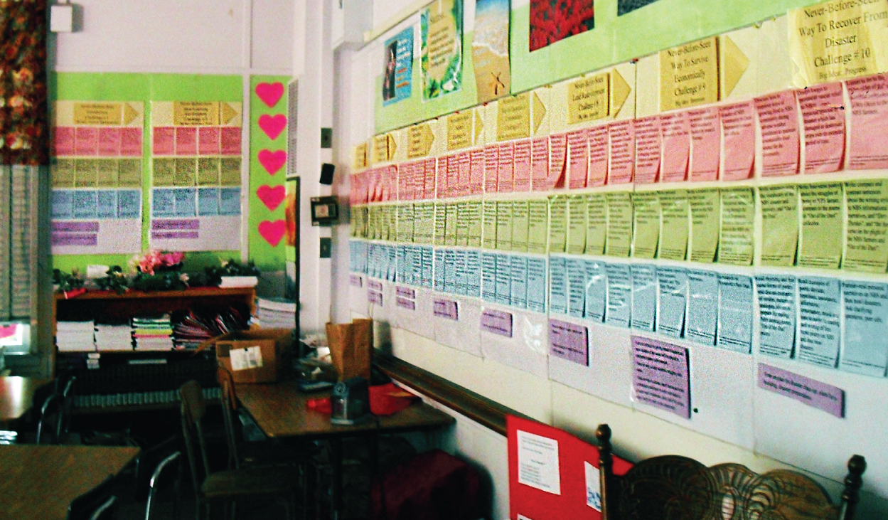 Photo depicts through the prominent display of her Long-Range Planning Boards, Annette Dellemonico taught her middle school ESL students the vocabulary of her planning for the school year and had them check off what they completed as a review of the relationship between the Design Challenges and Guided Lessons.