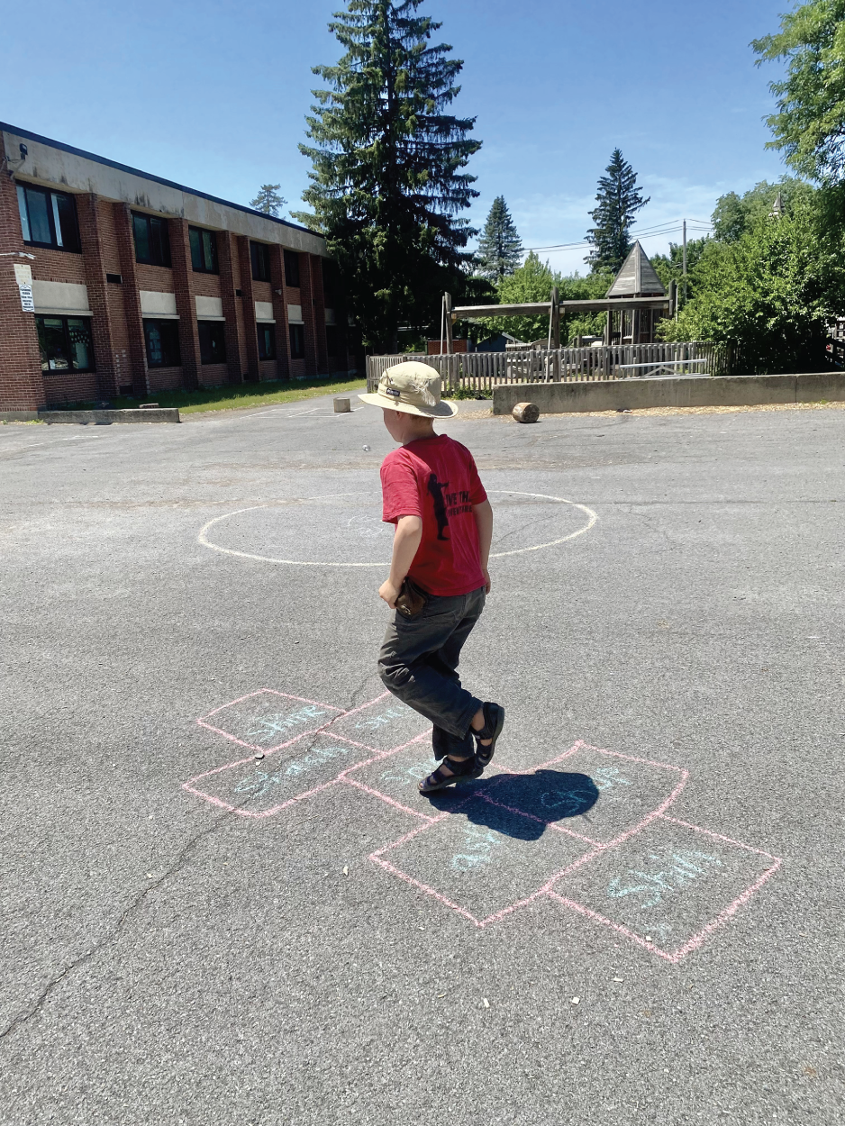 Photo depicts playing hopscotch to review the digraph SH