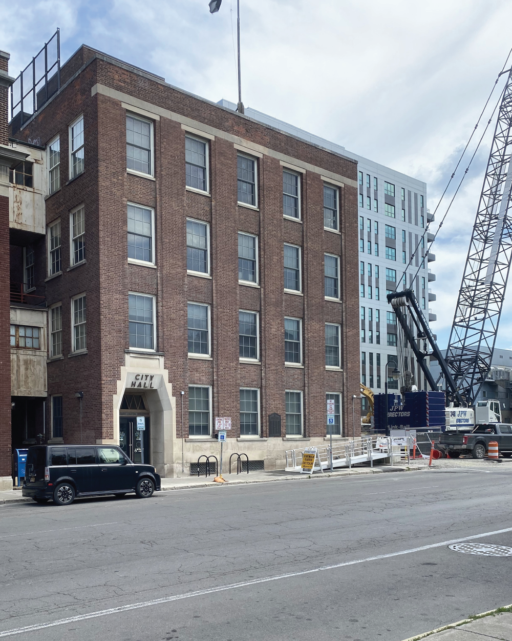 Photo depicts look at all the rectangles and squares on buildings
and the triangles on the crane