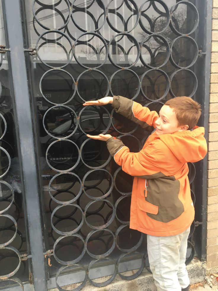 Photo depicts this building has a giant array of circles on the front