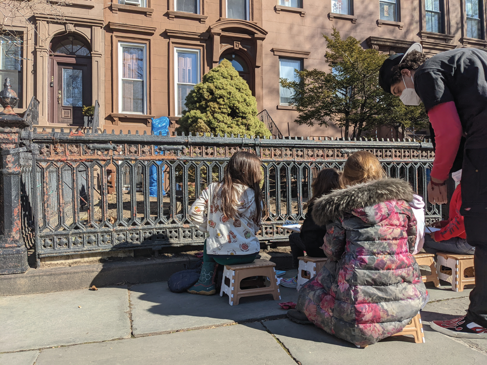 Photo depicts students from The Brooklyn New School observing
and drawing trees