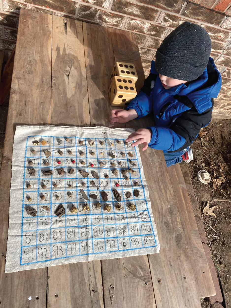 Photo depicts collecting 100 rocks using a 100 chart