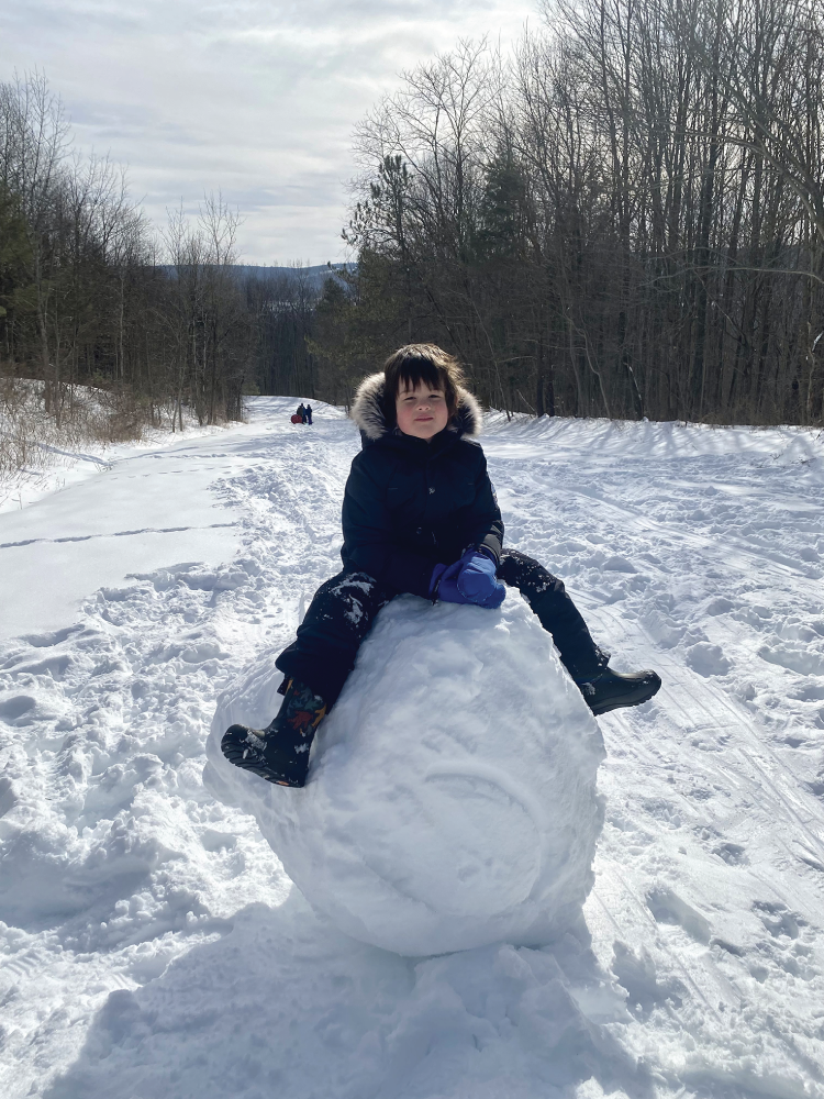 Photo depicts building a giant snow person.