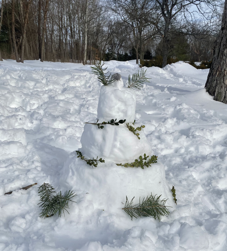 Photo depicts building and decorating a snow cake is a fun alternative to snow creatures.