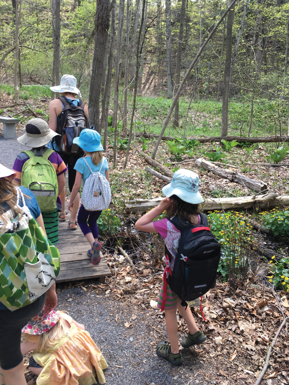 Photo depicts students headed to explore a nature preserve.