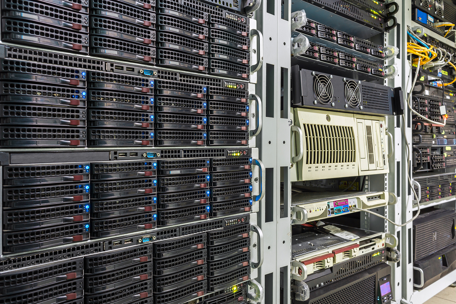 A photo shows racks of servers in a data center facility.
