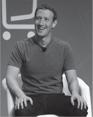 A photograph of Facebook CEO Mark Zuckerberg seated on a chair.