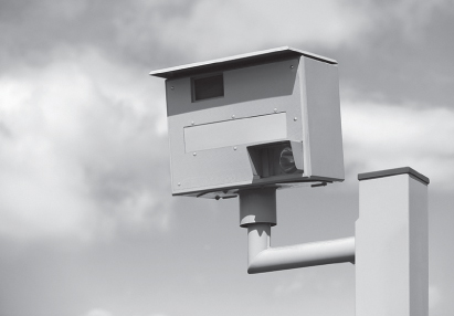 A photograph of a traffic speed camera mounted on a pole.