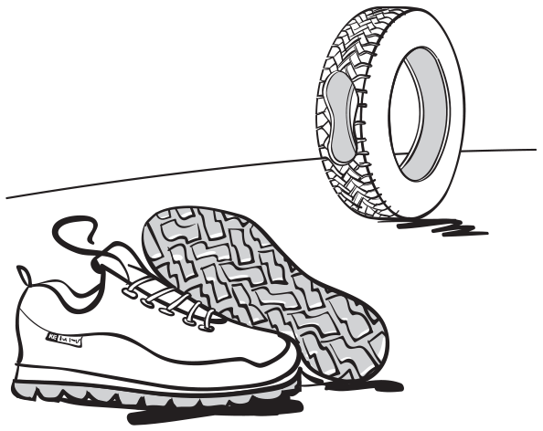 A pair of shoes; whose soles seem to have been cut out of a used tyre shown rolling next to them. The gap created by the sole cut out can be seen from the outside of the tyre.