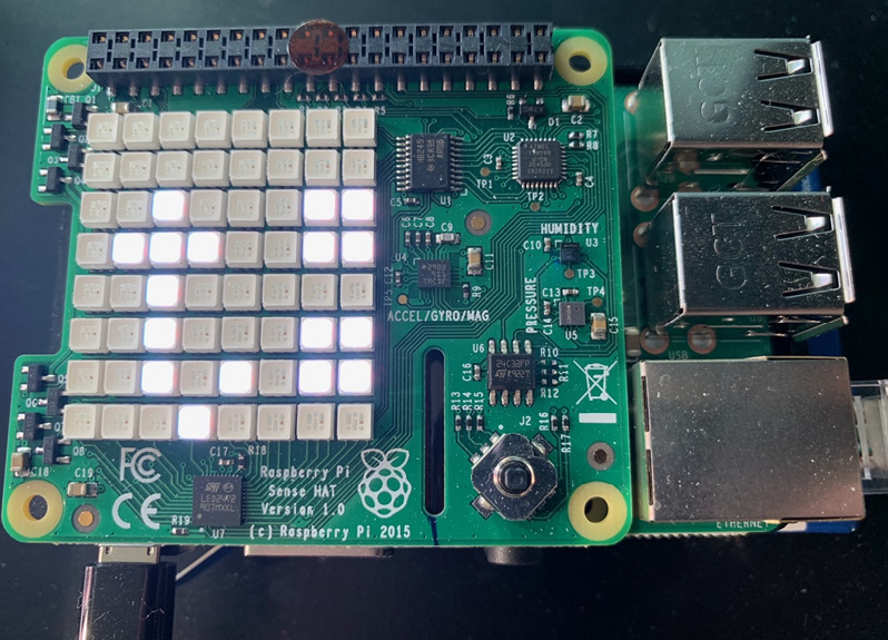 Figure 3.11 – A photograph of Sense HAT scrolling through reported sensor values
